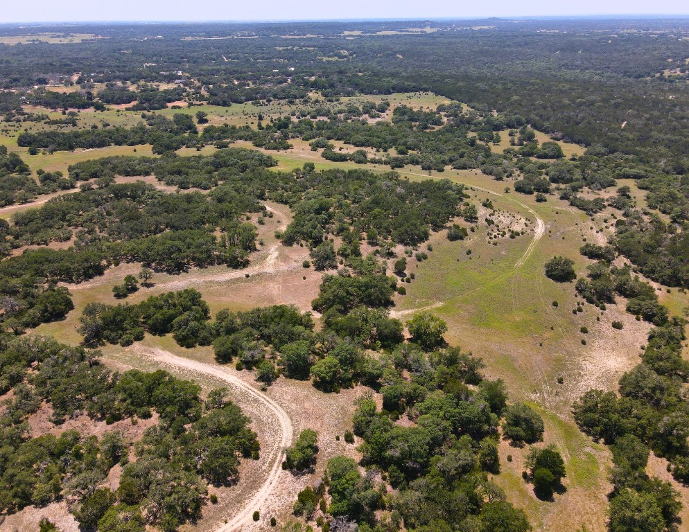 an aerial view of mountain with yard and mountain view in back