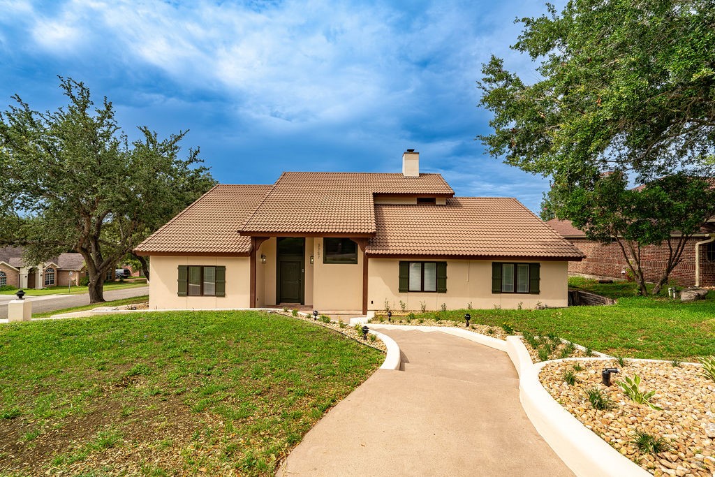 a front view of a house with a yard