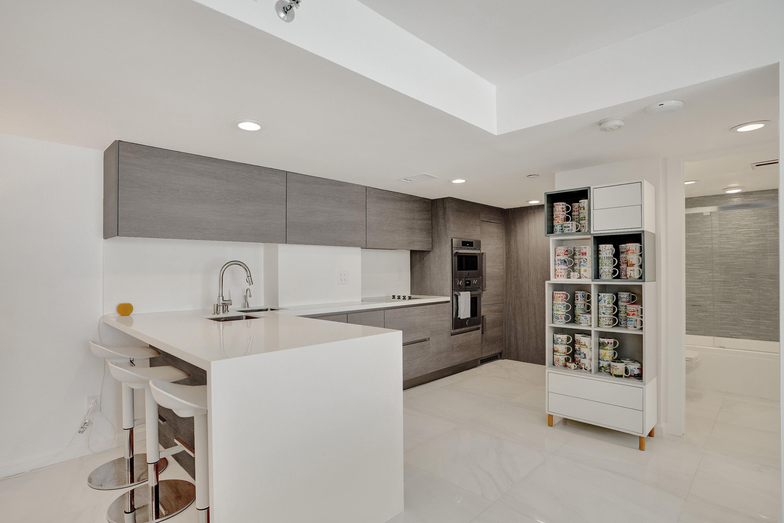 a kitchen with stainless steel appliances a stove a sink and a refrigerator