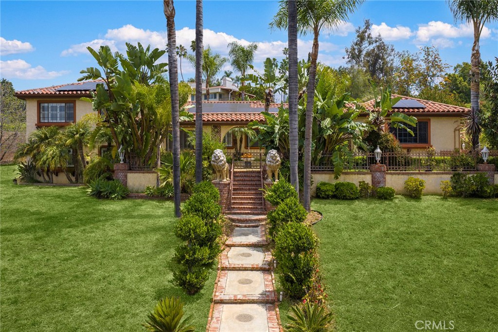 a front view of a house with a garden