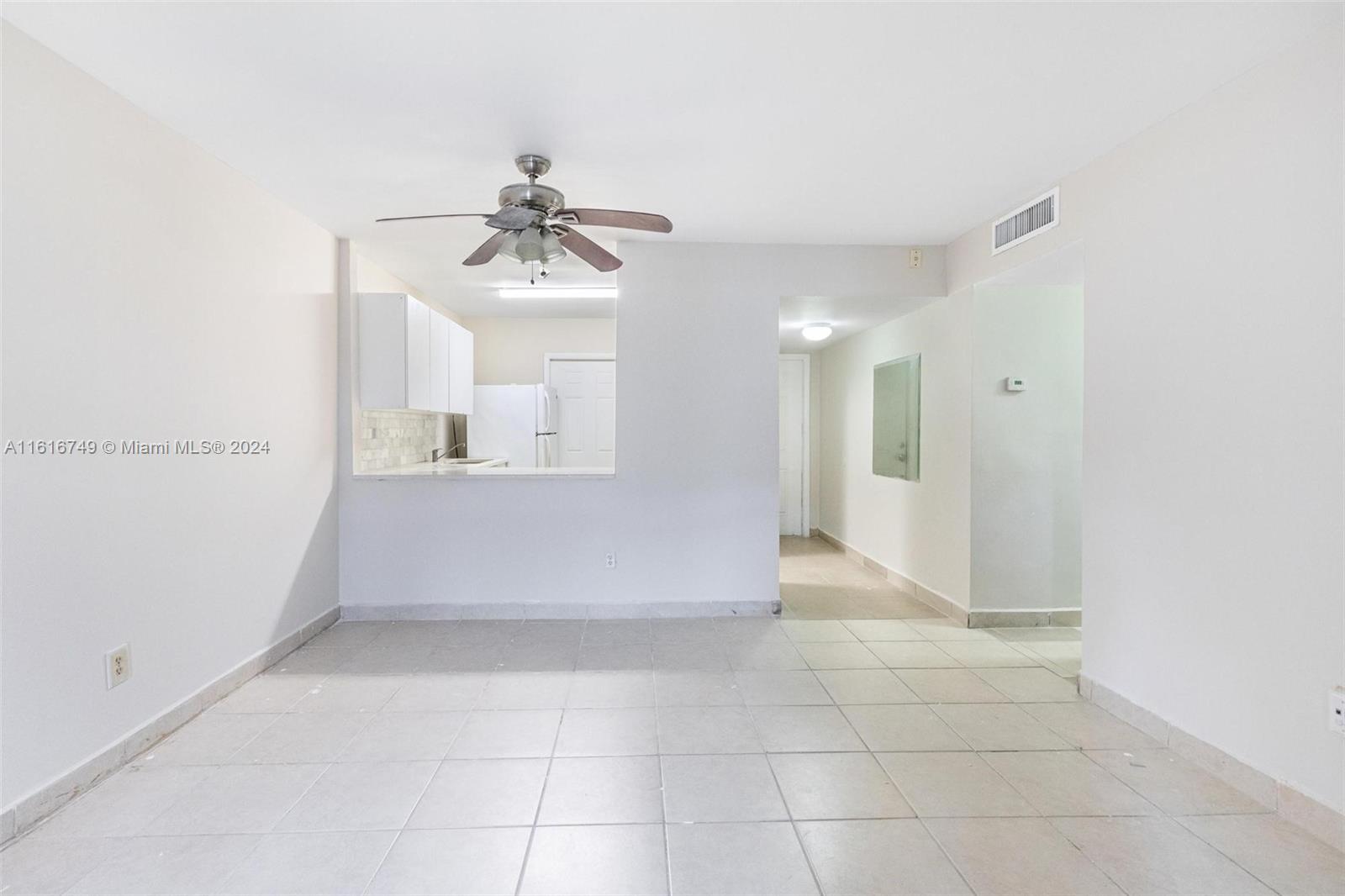 a view of a kitchen with a sink and a mirror