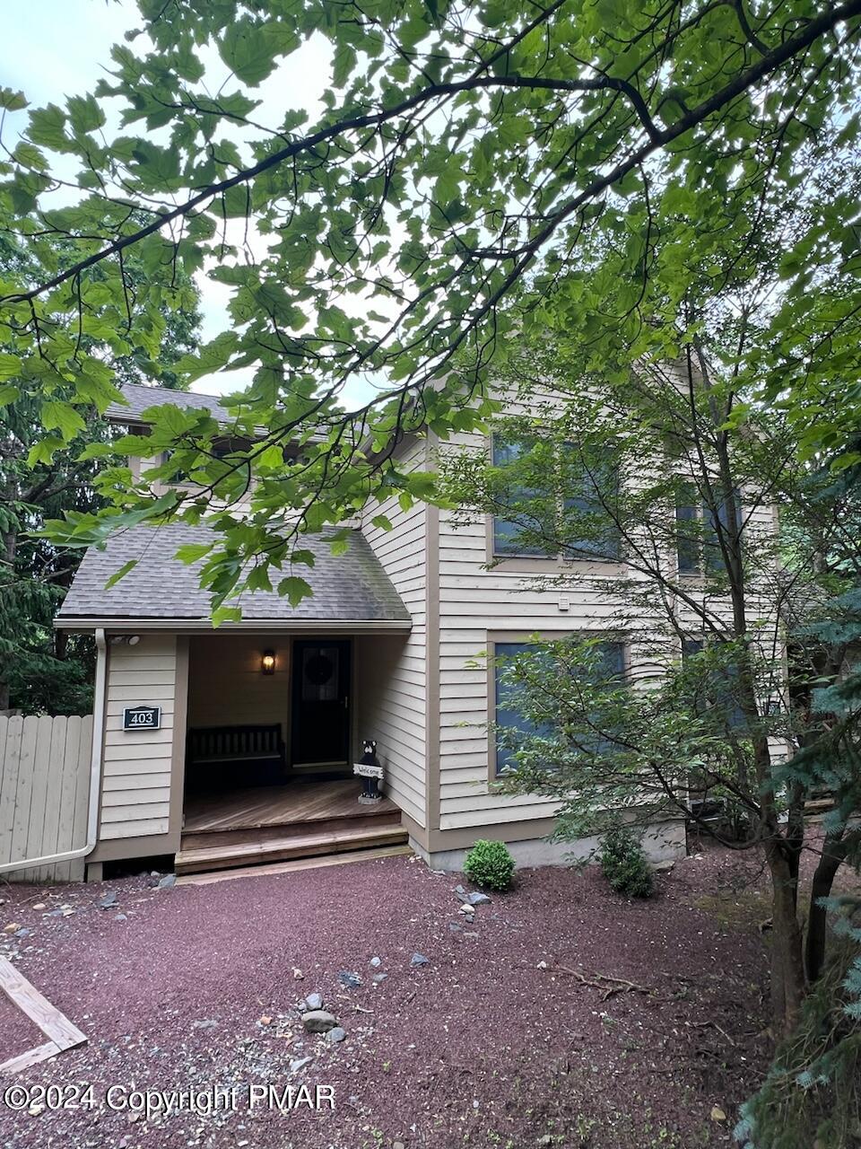 a view of a house with a tree and a yard