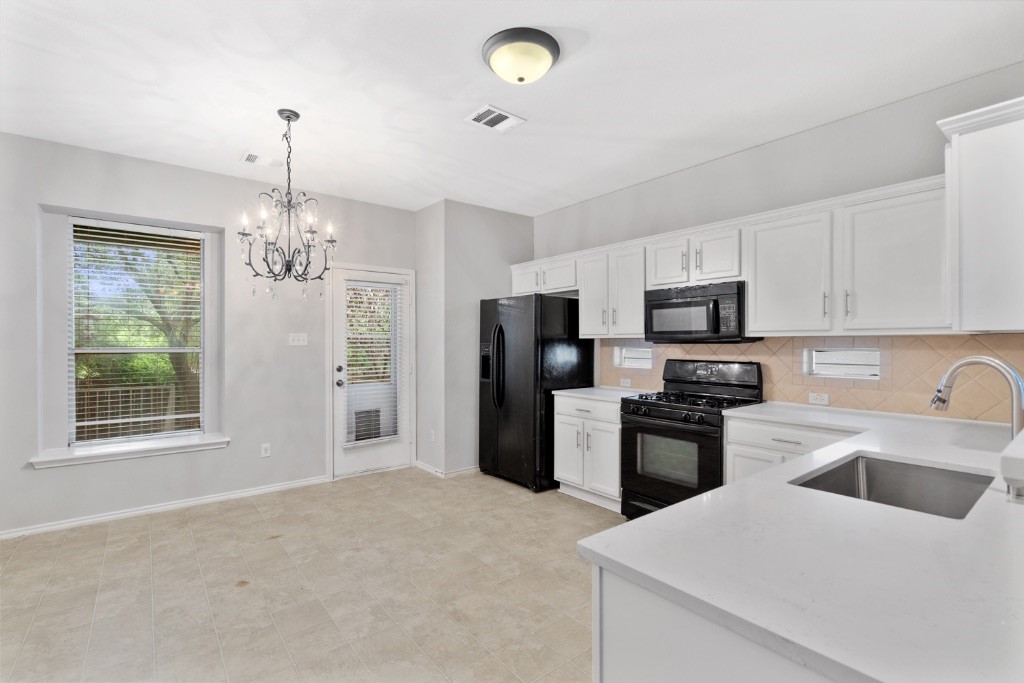 a kitchen that has a refrigerator and a sink