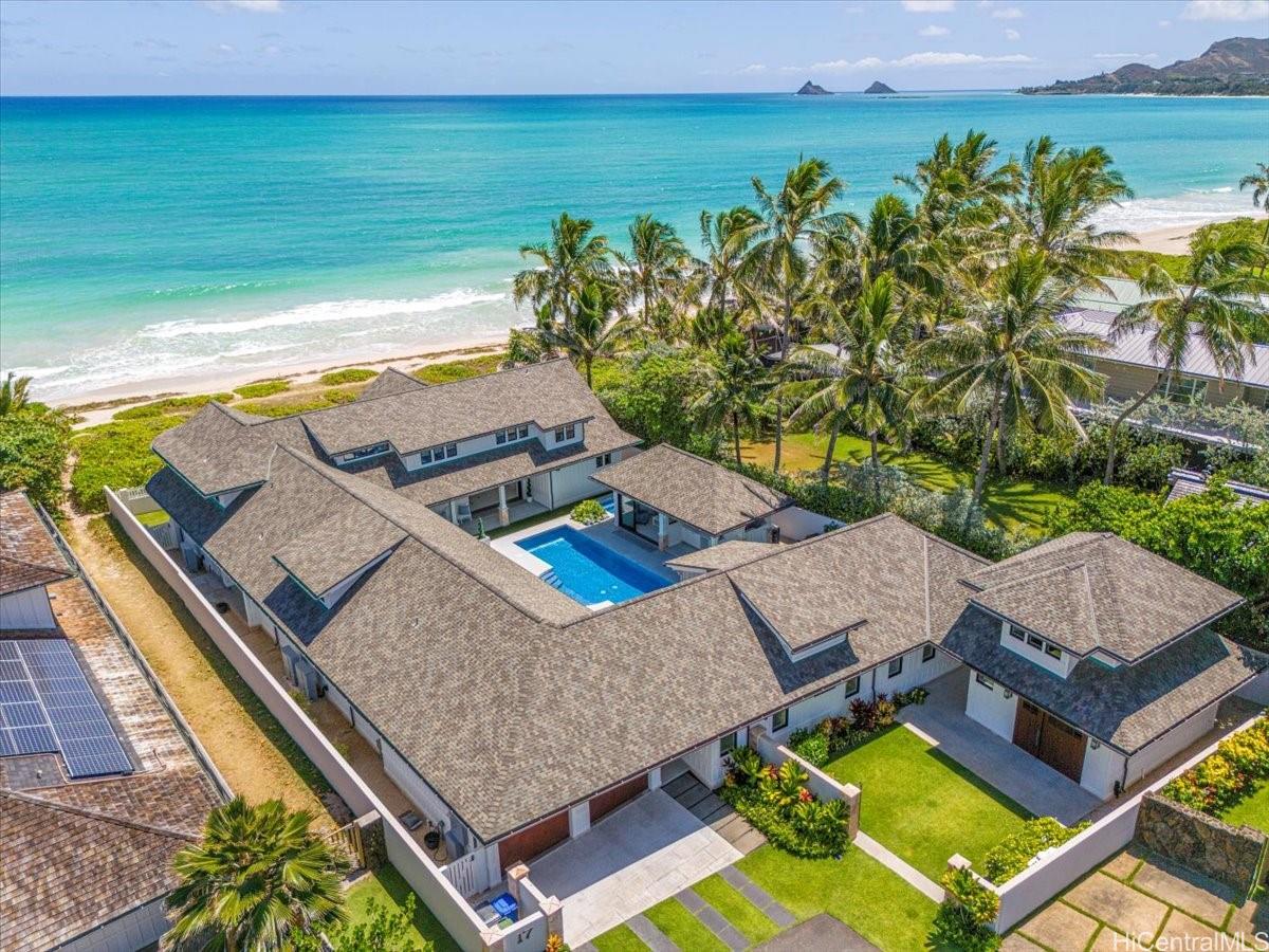 a view of a patio with lawn chairs next to an ocean