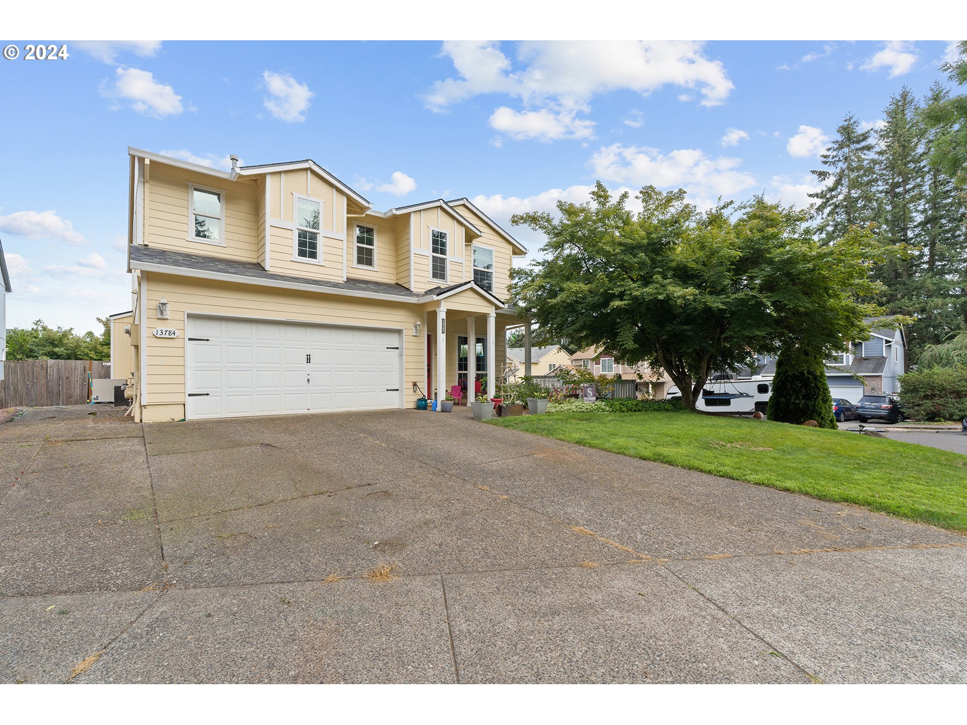 a view of a house with a yard and garage