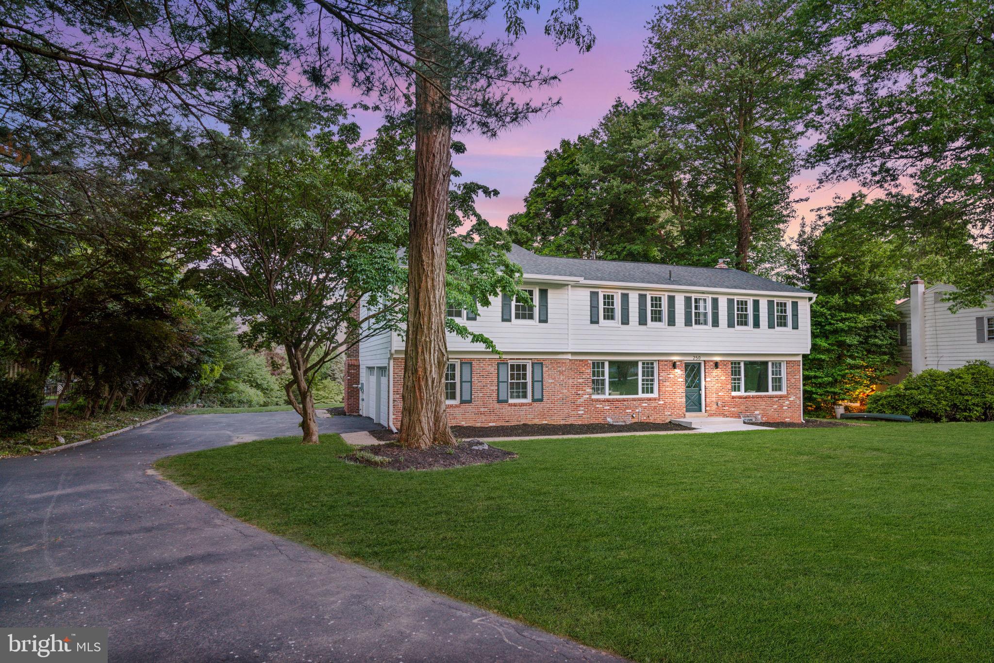 a view of a house with a yard and a garden