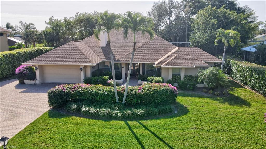 a front view of house with a garden and plants