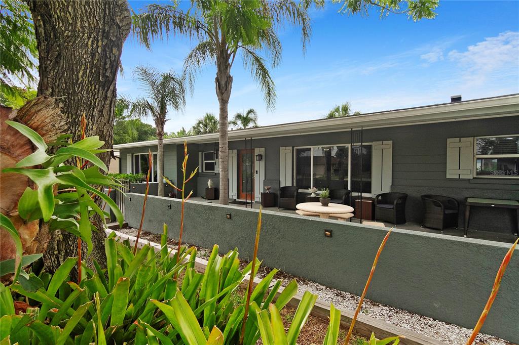 a view of house with outdoor space and swimming pool