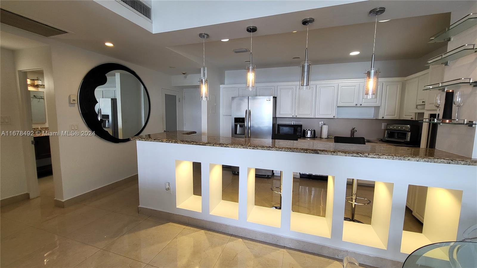 a kitchen with stainless steel appliances granite countertop a stove a sink and a granite counter tops