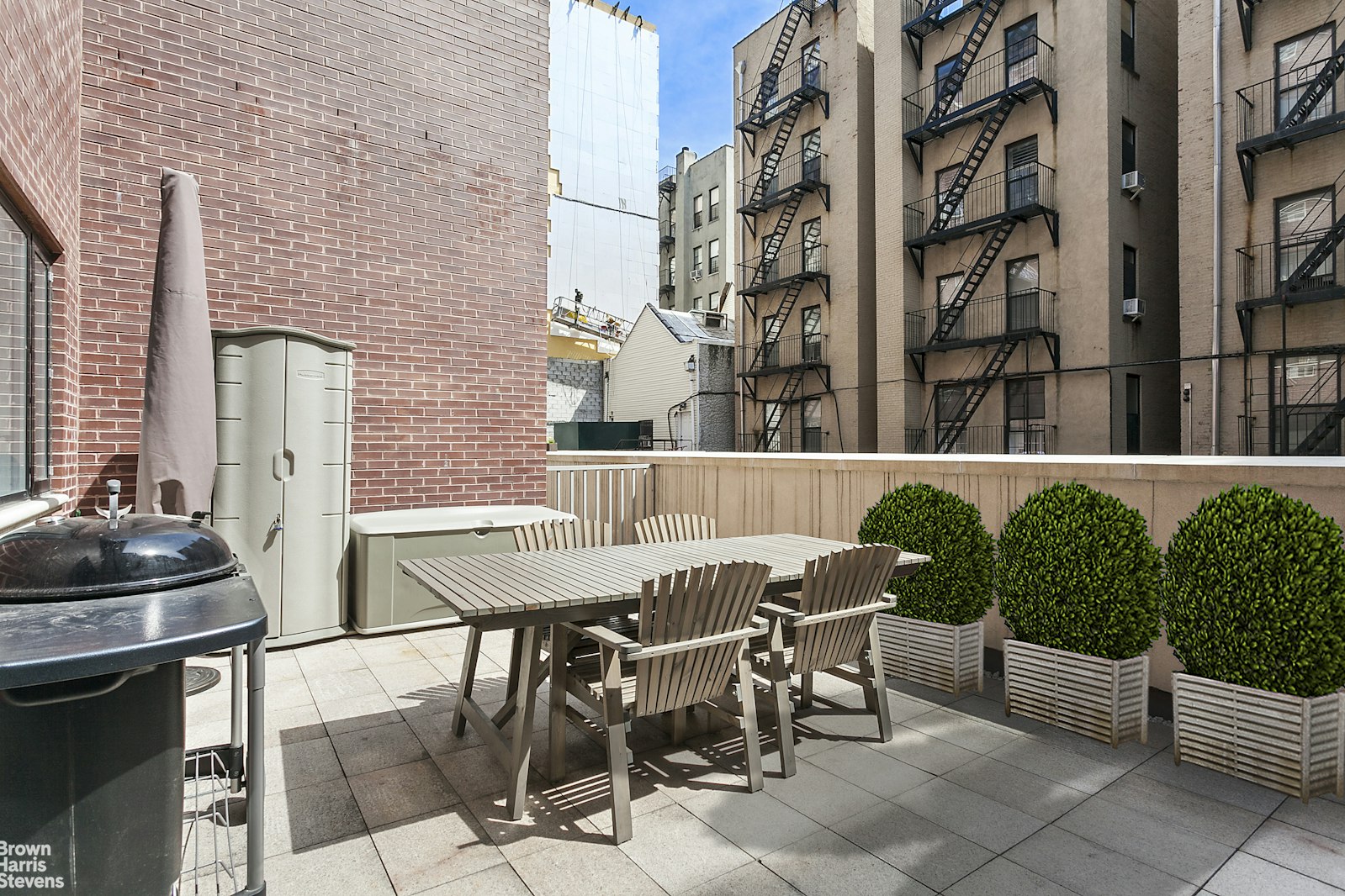 a view of a patio with a table and chairs and potted plants