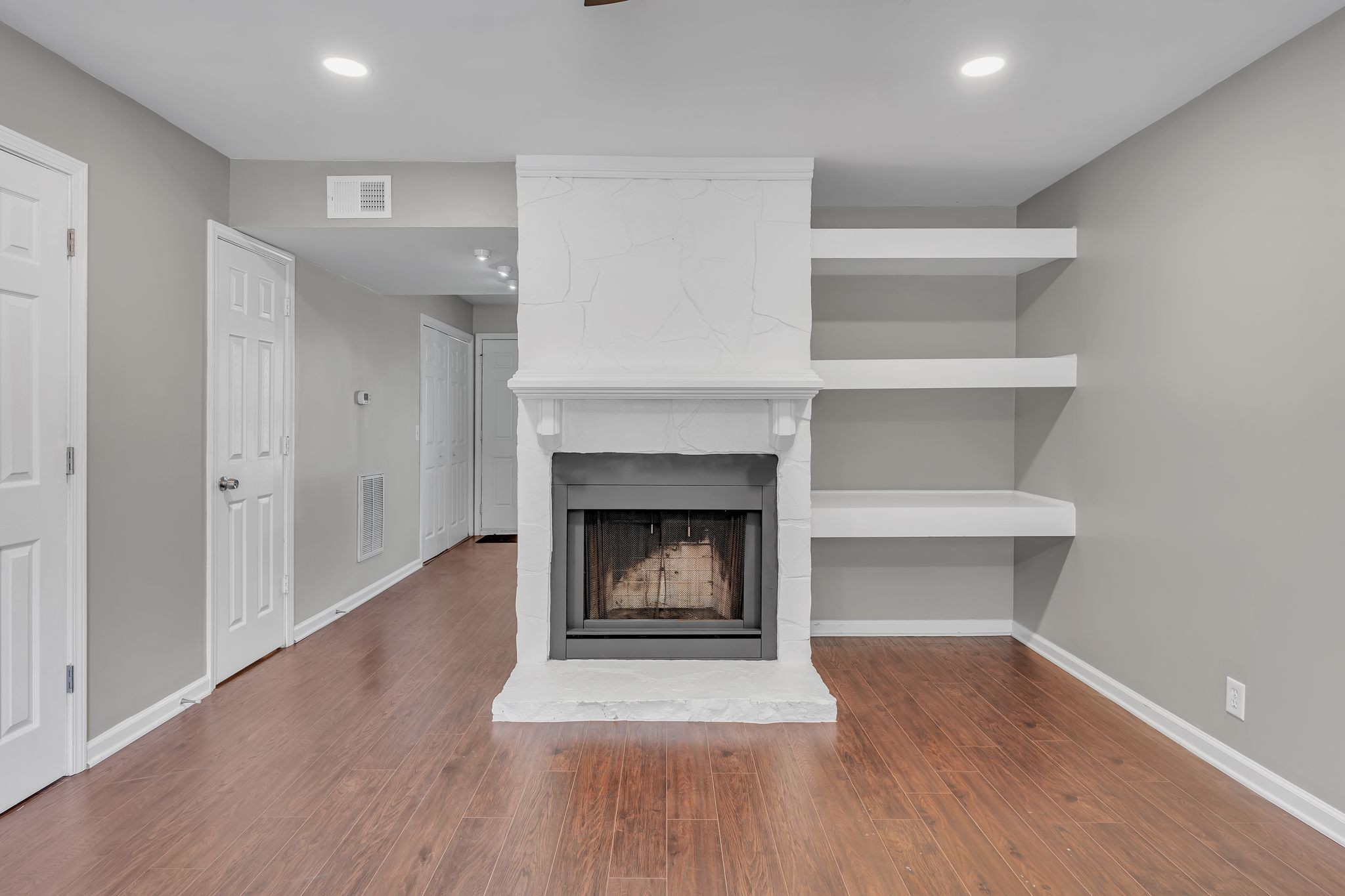 a living room with a fireplace and a fireplace