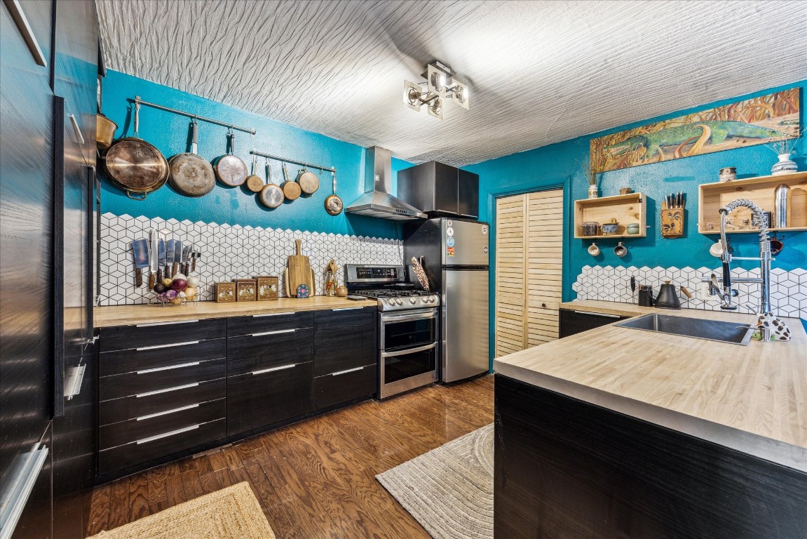 a kitchen with stainless steel appliances granite countertop a sink and cabinets