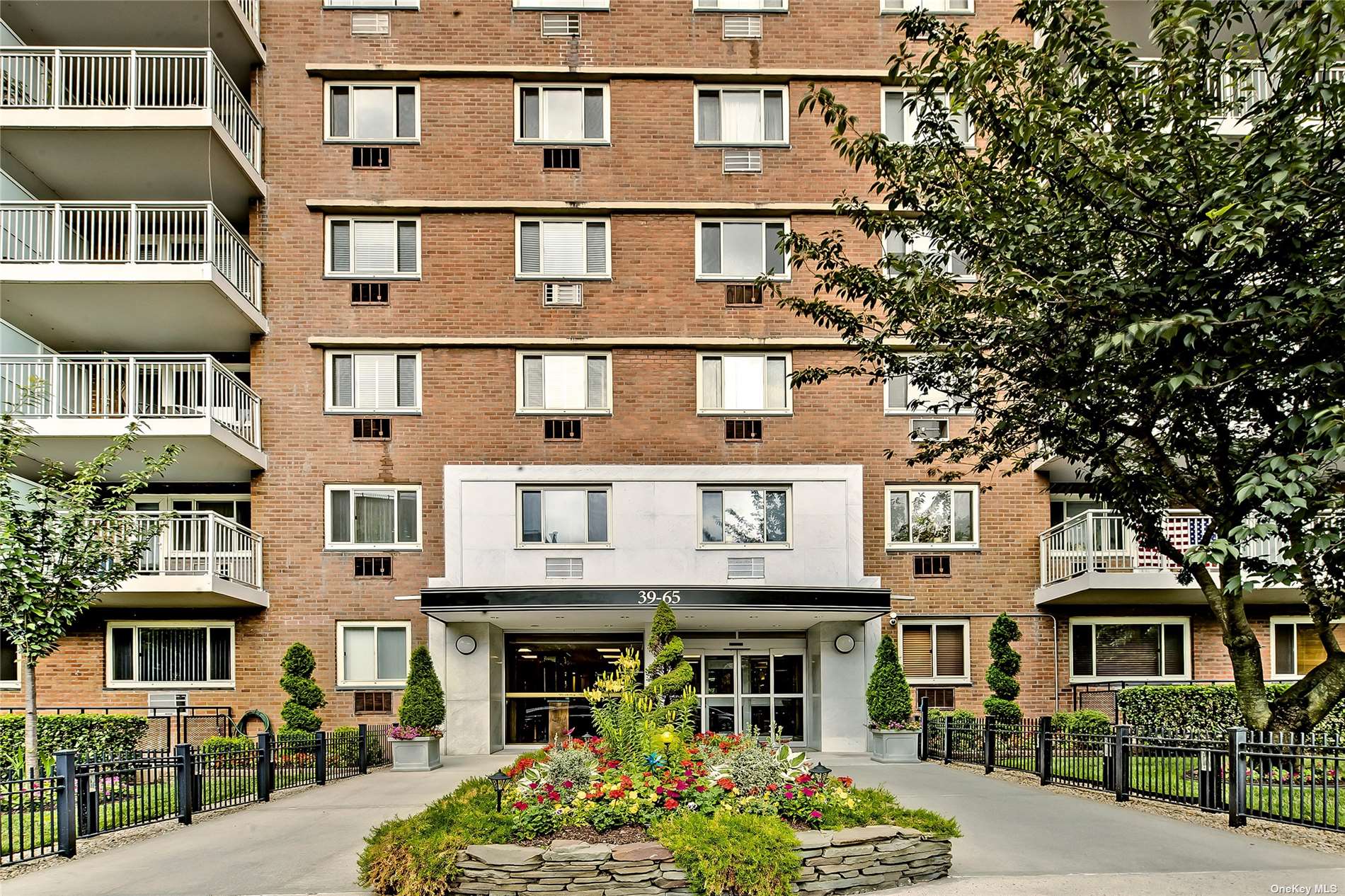 a front view of a residential apartment building with a yard