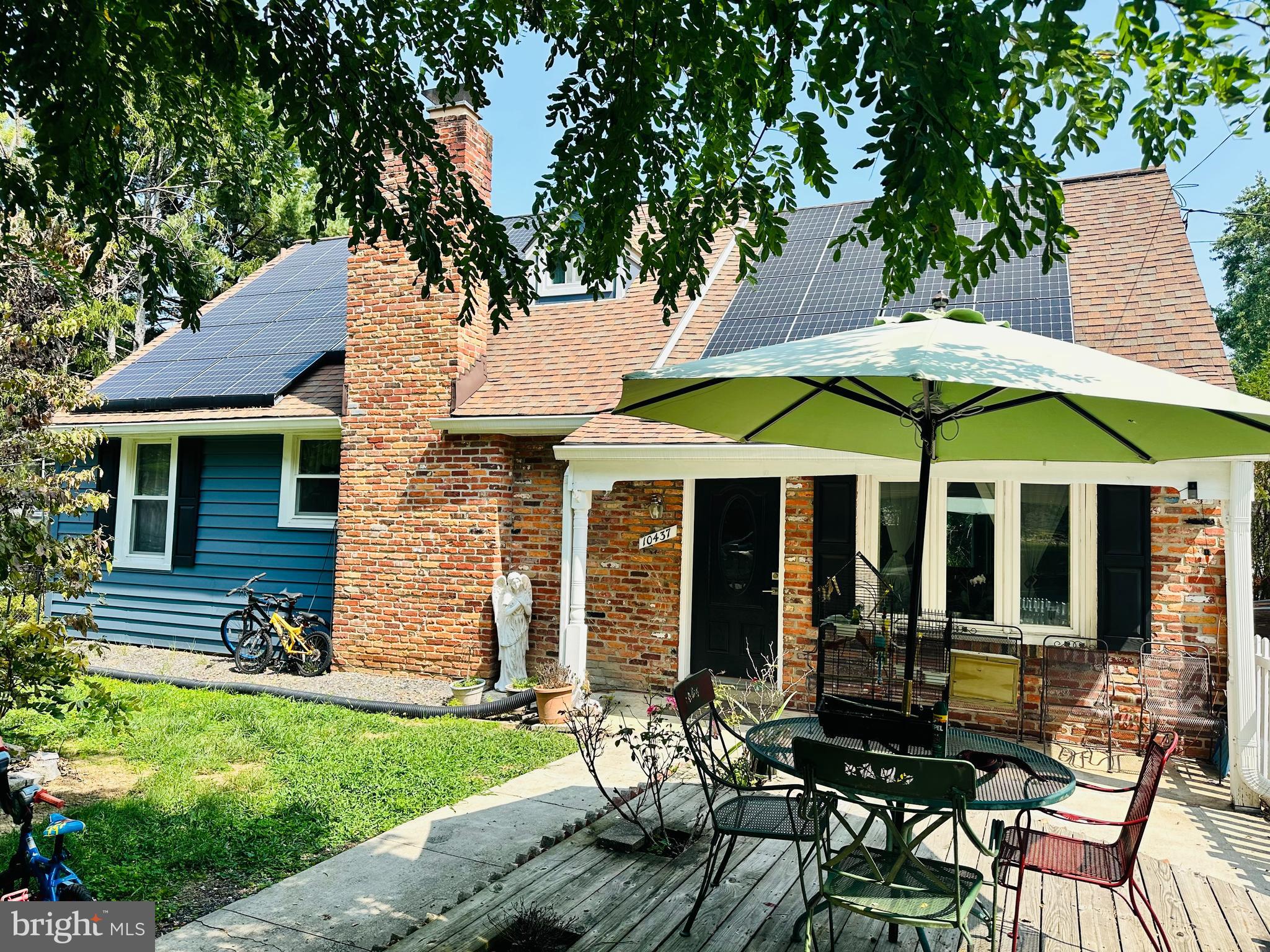 a view of a house with a yard and sitting area