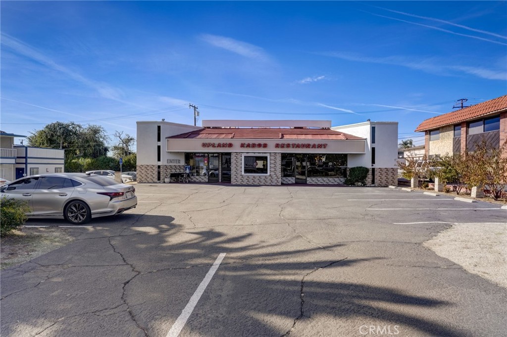 a view of building with cars parked