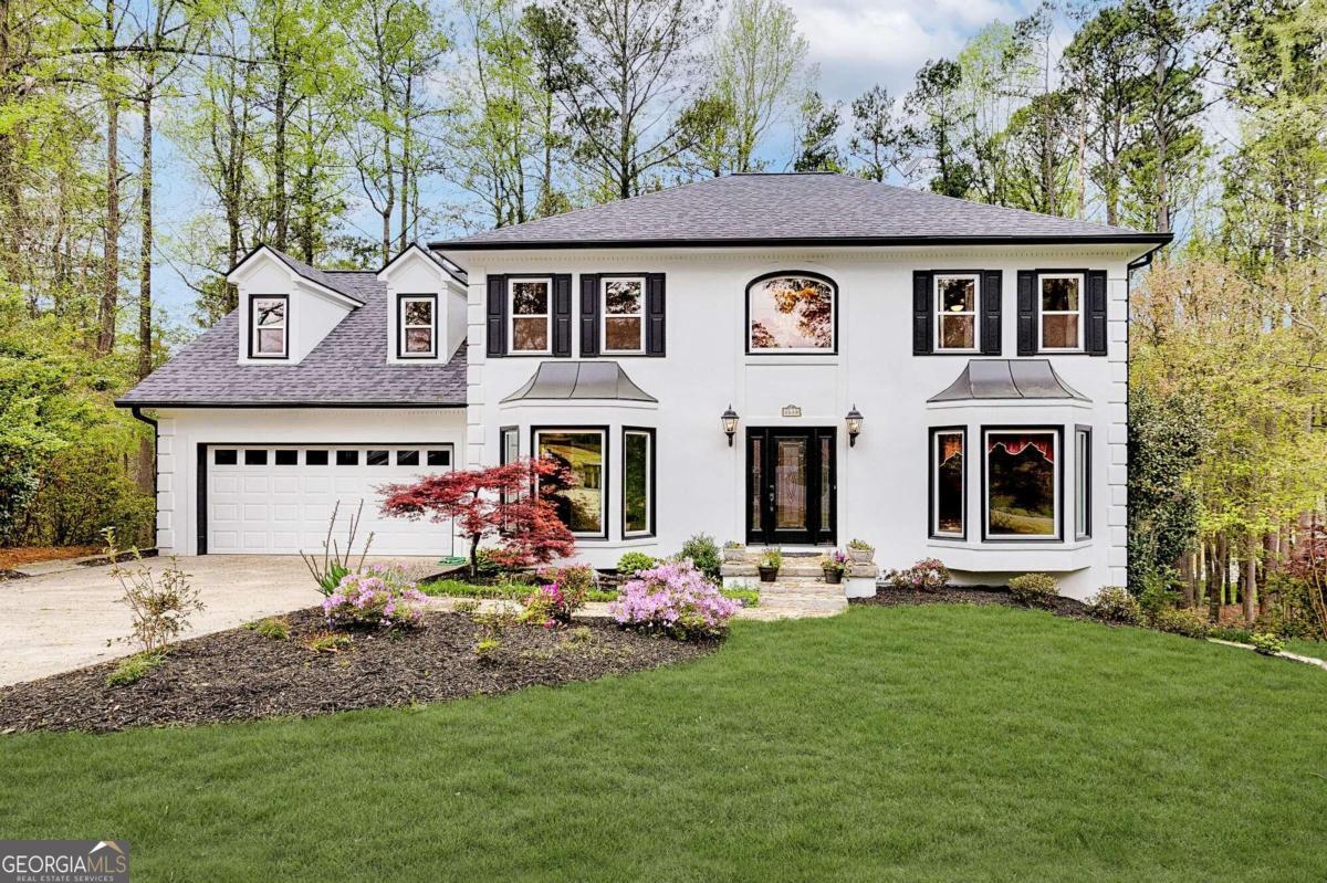 a front view of a house with garden