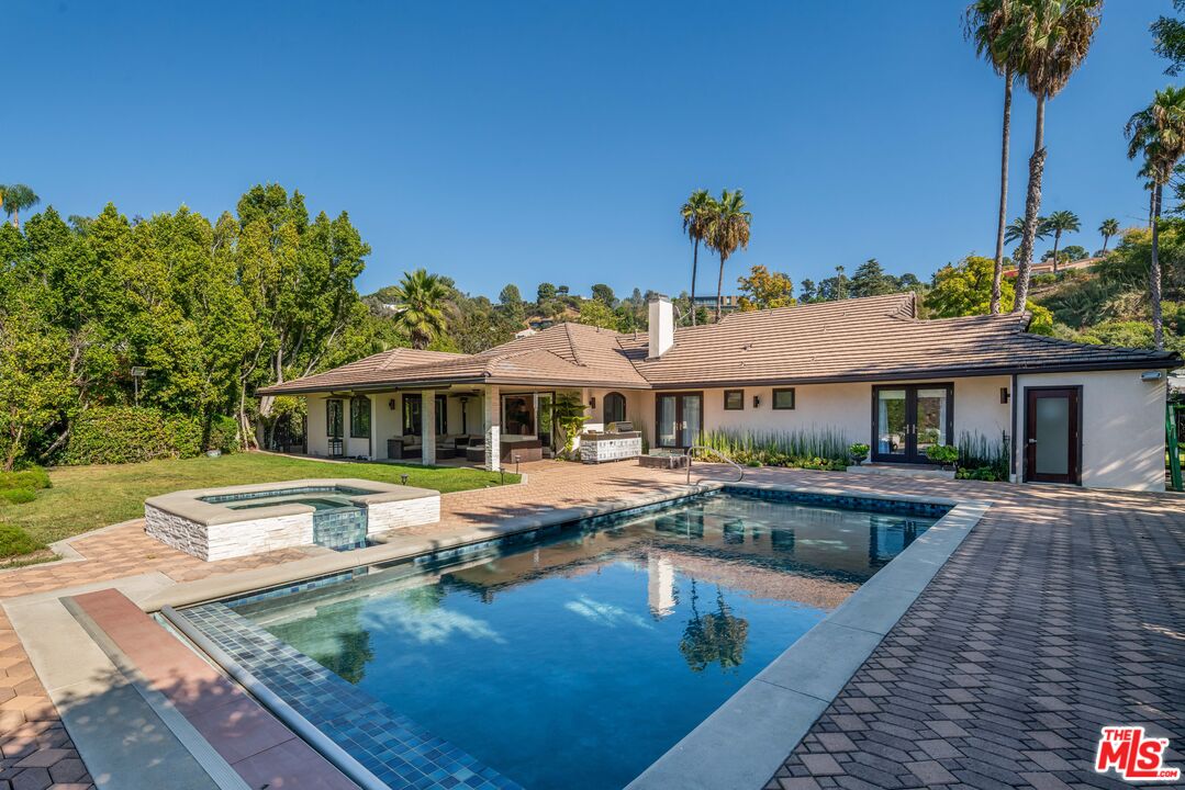 a view of a house with swimming pool and sitting area