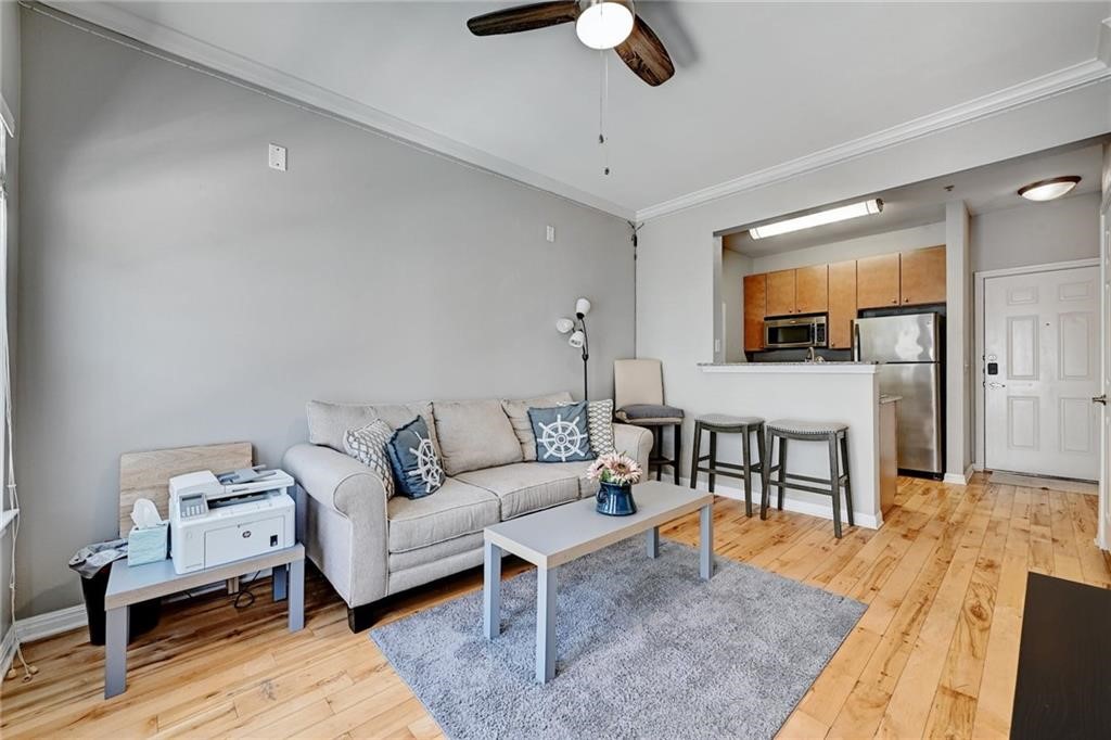 a living room with furniture and a wooden floor