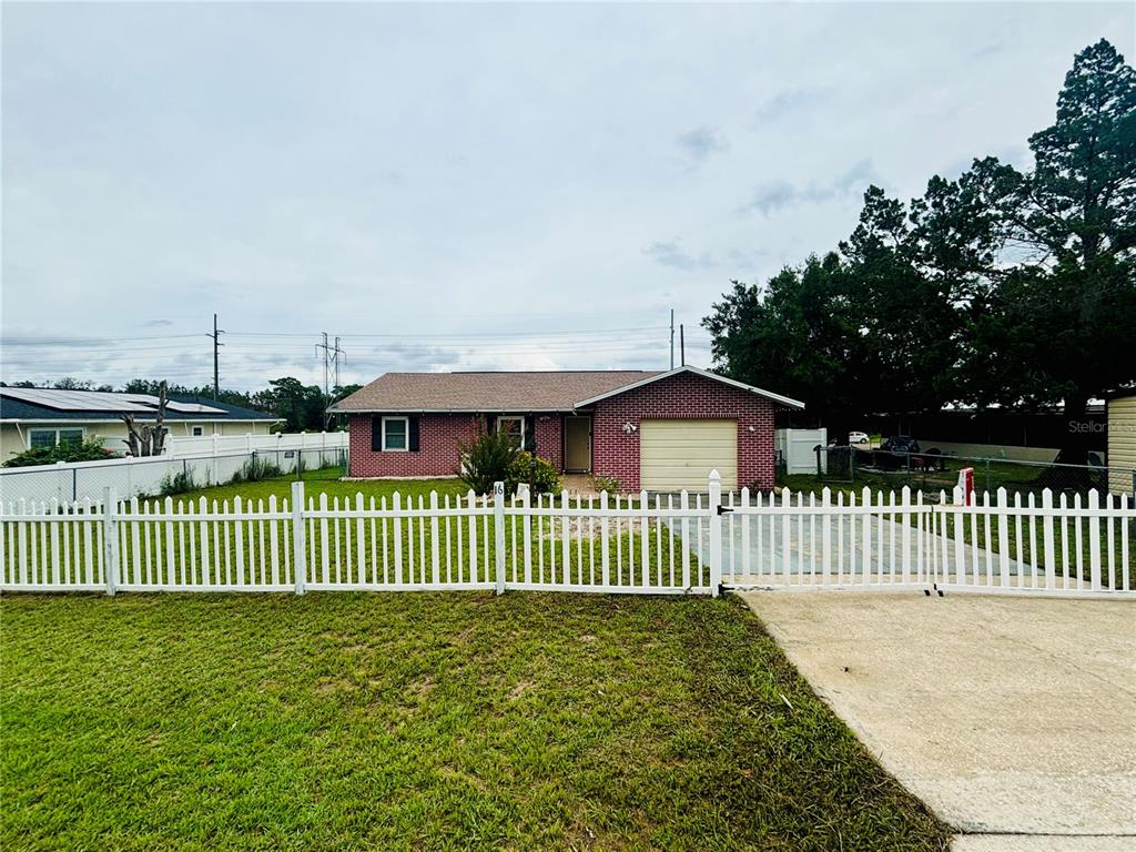 a view of a house with a wooden fence