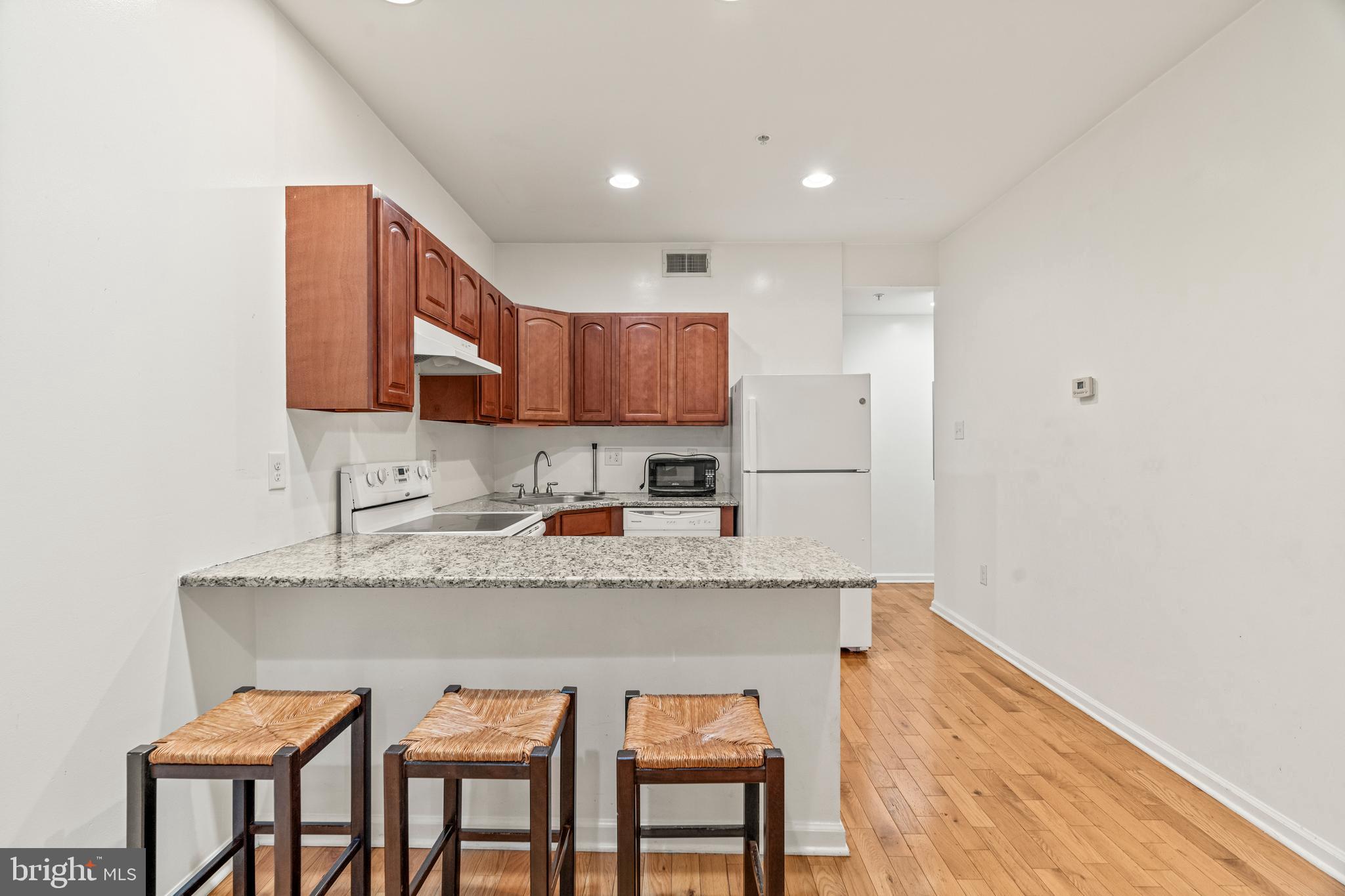 a kitchen with stainless steel appliances granite countertop a sink stove and cabinets