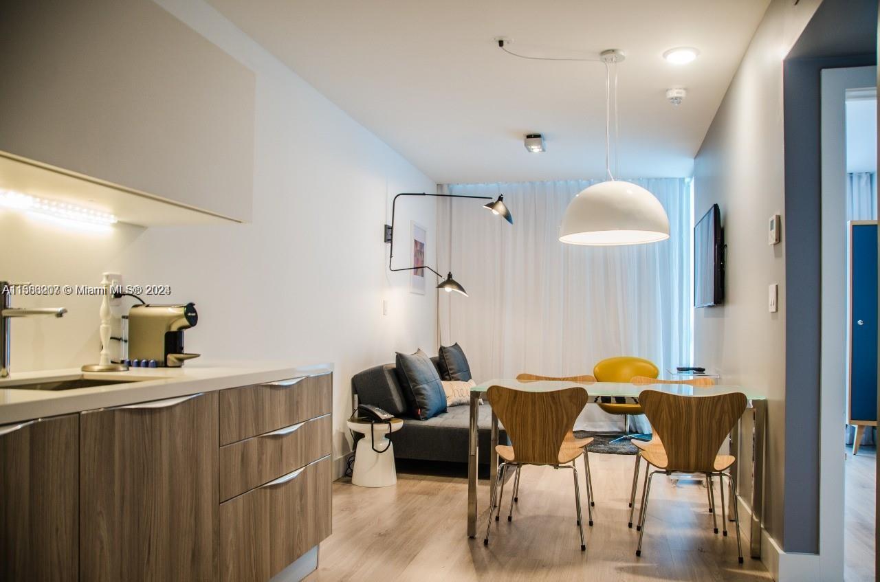 a dining room with furniture and a mirror