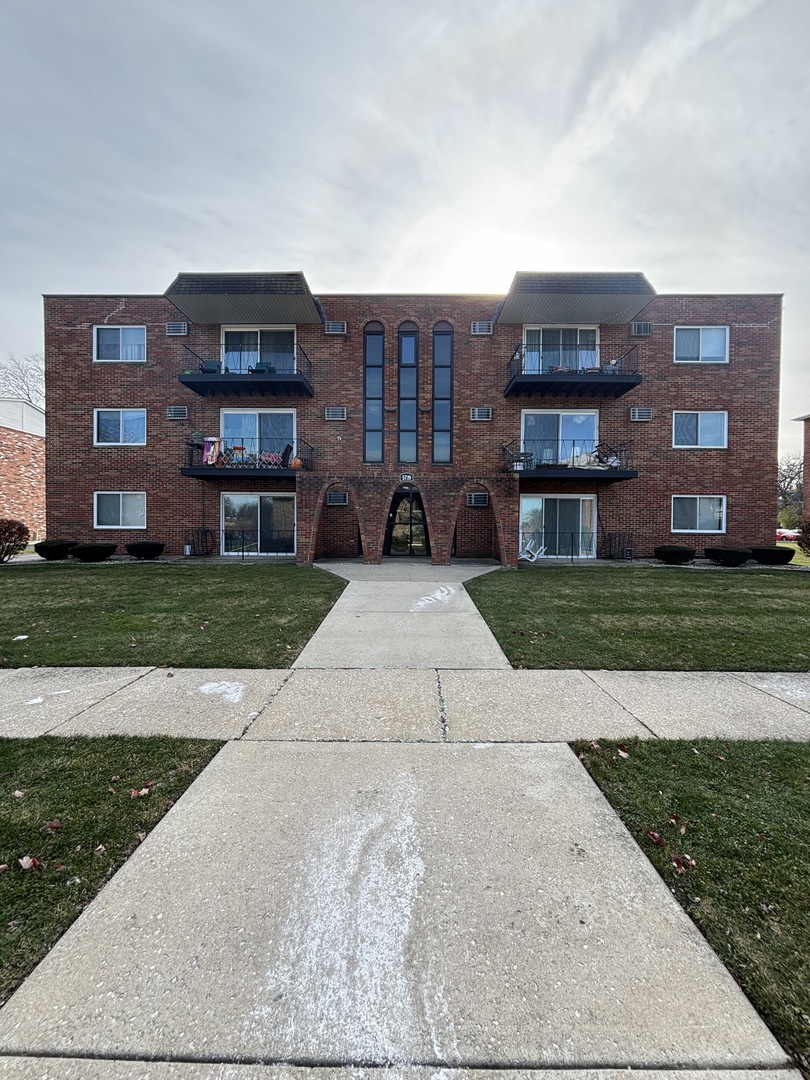 a view of a brick building next to a yard