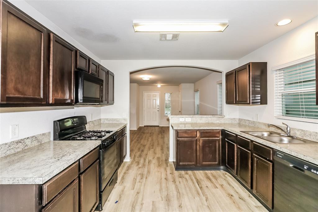 a kitchen with stainless steel appliances granite countertop a stove and a sink