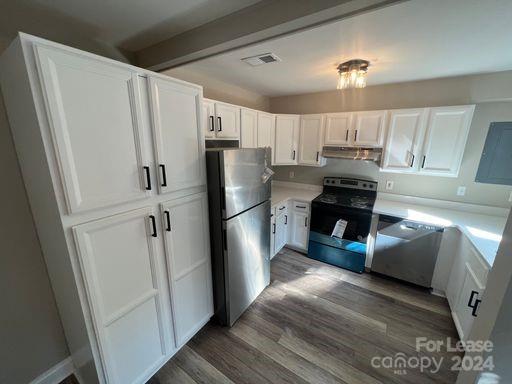 a kitchen with stainless steel appliances a refrigerator a sink a stove a microwave and island