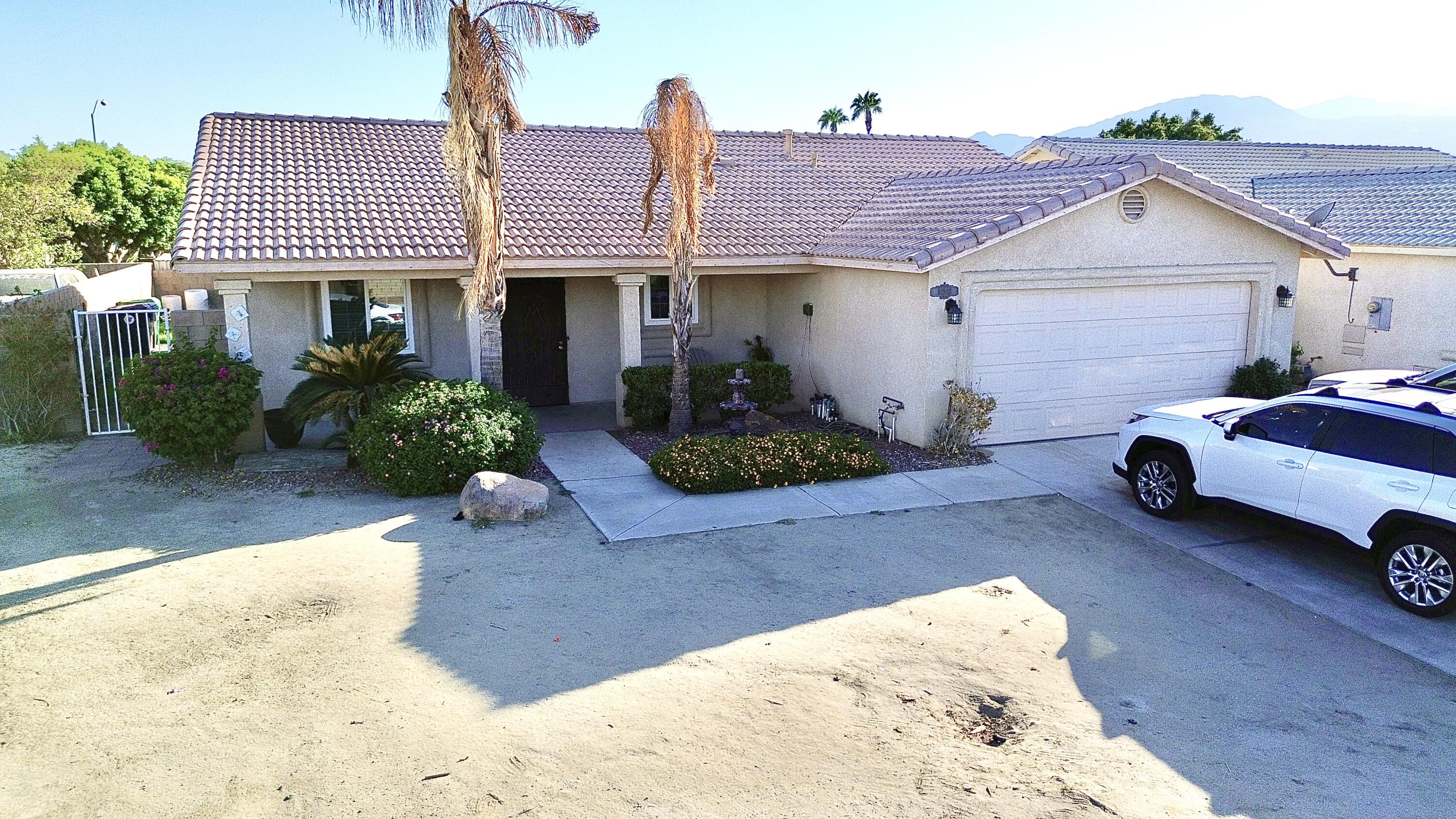 a front view of a house with garden