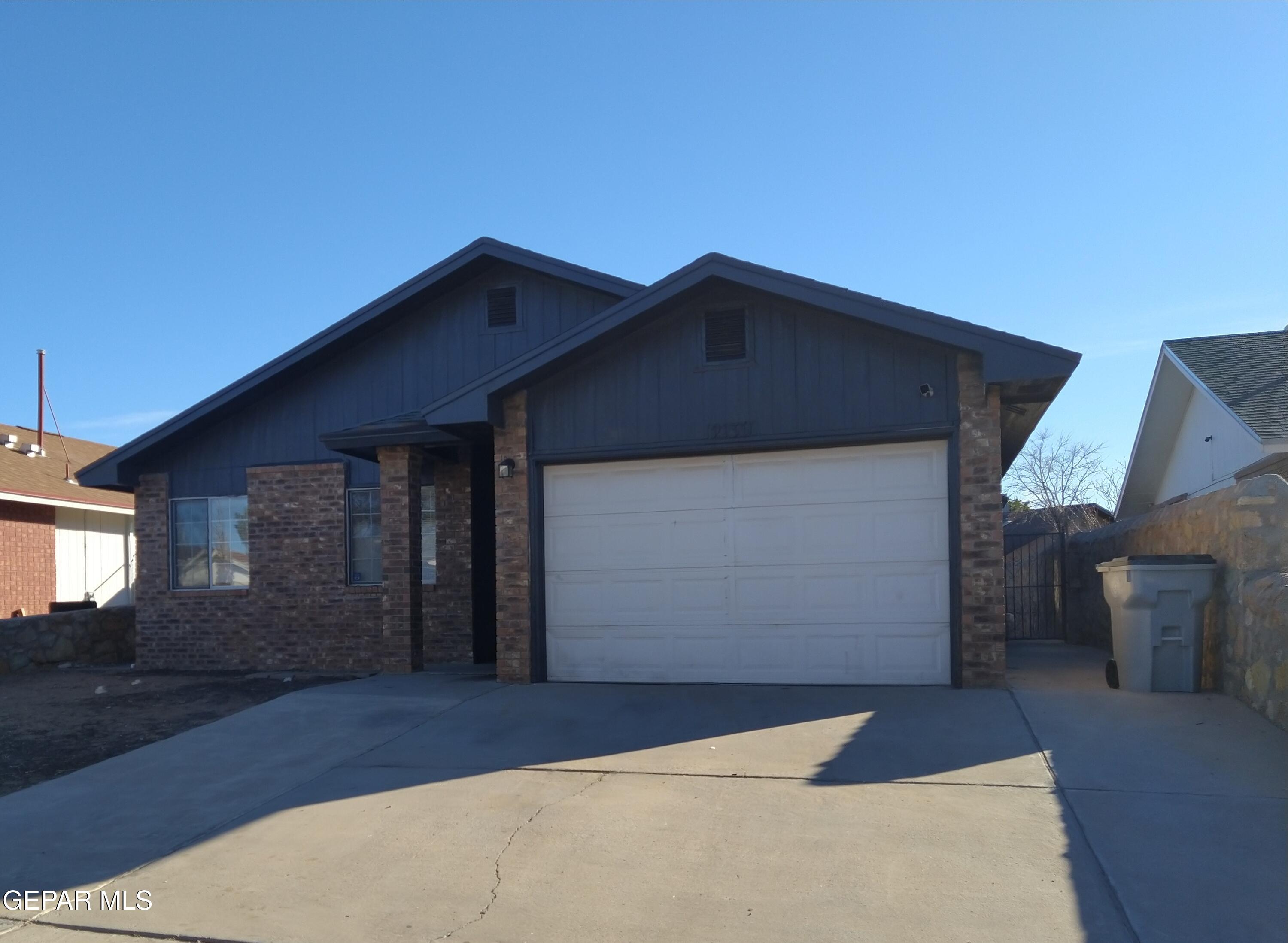 a front view of a house with garage