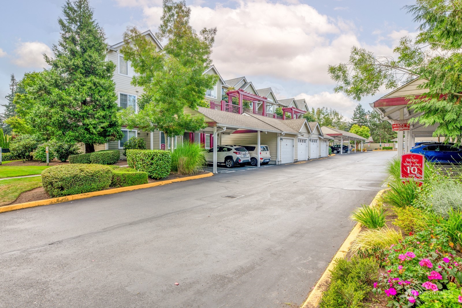 a car parked in front of a house with a small yard