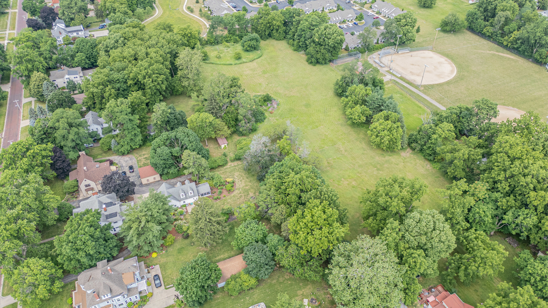 an aerial view of a house with a yard