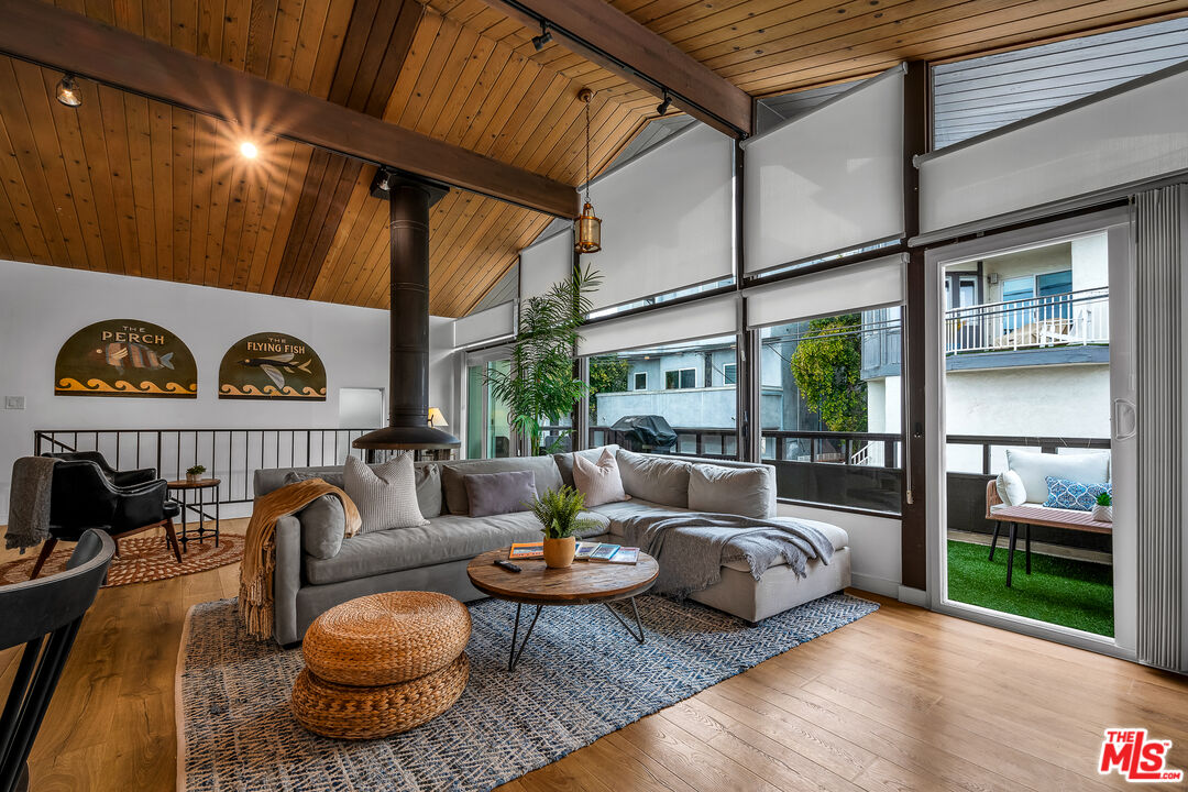 a living room with furniture and a floor to ceiling window