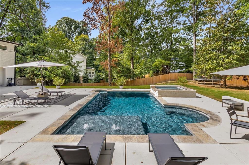 swimming pool view with a seating space