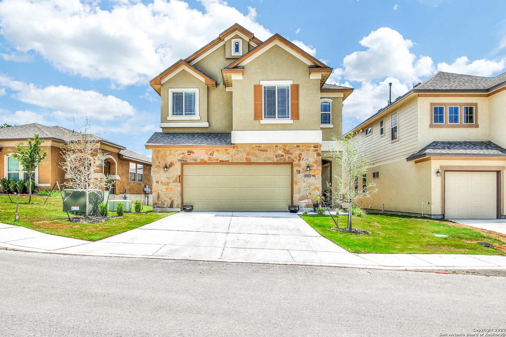 a front view of a house with a yard and garage