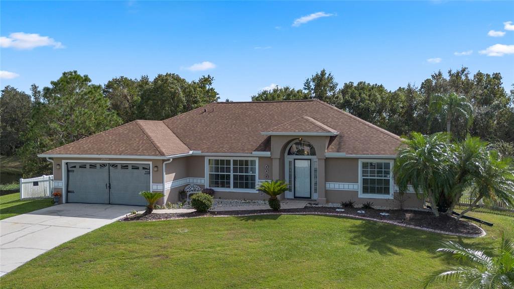 a view of a house with swimming pool and a yard