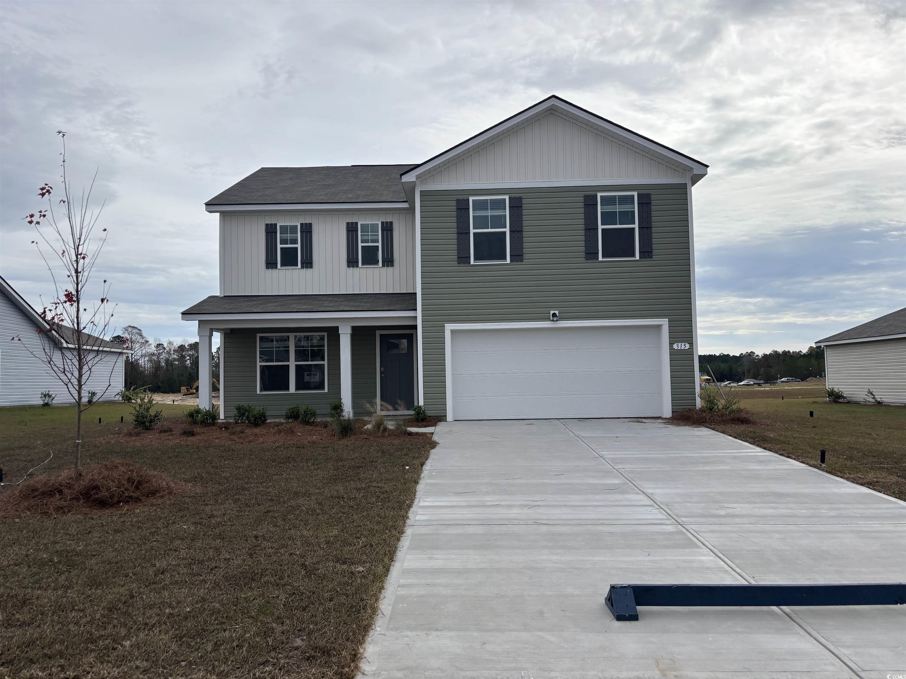 View of front of home featuring a garage and a fro