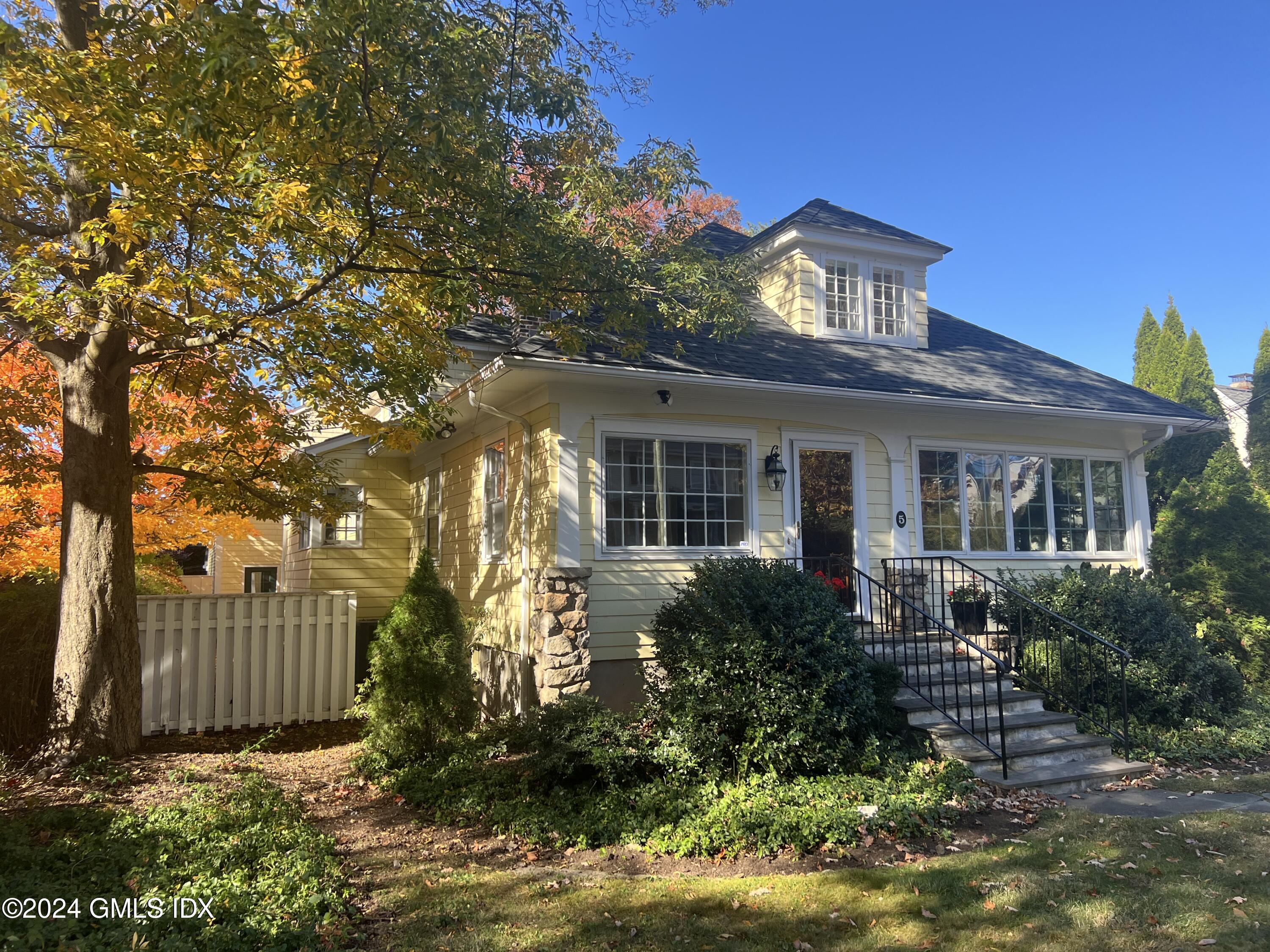 a front view of house with yard and green space