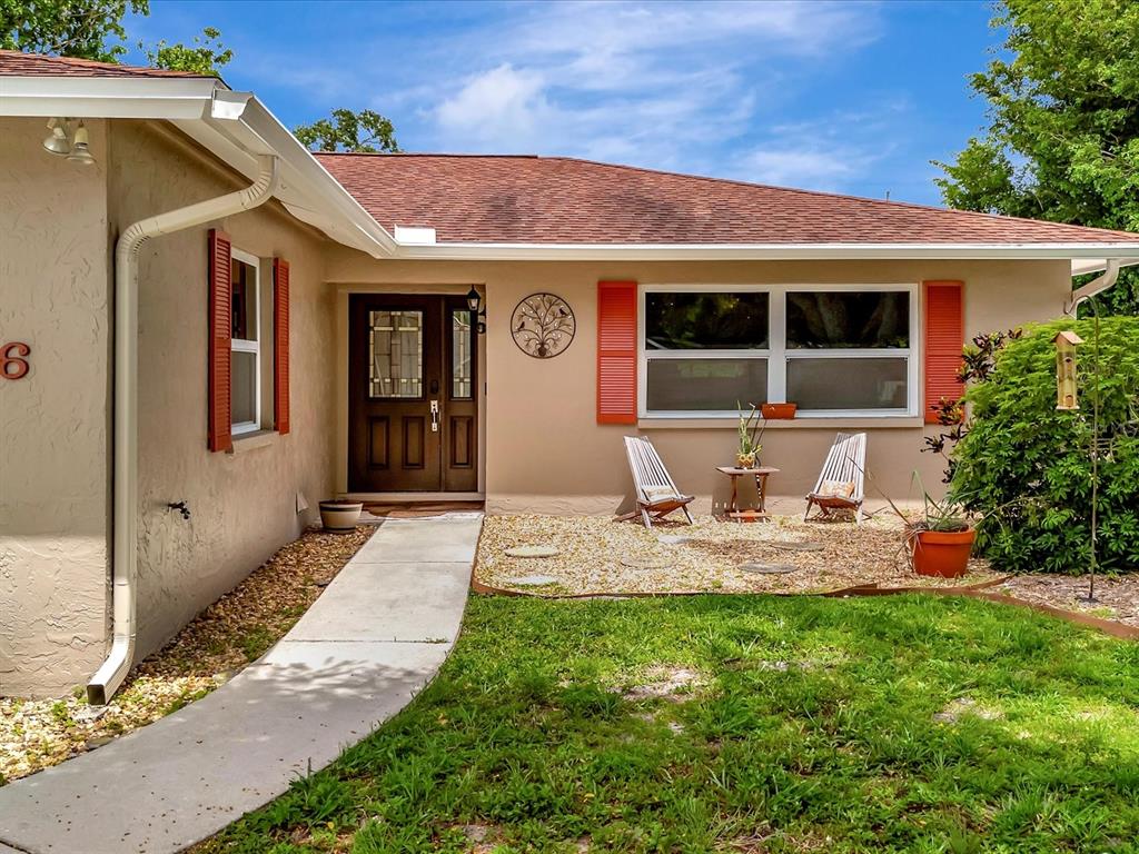 a front view of a house with sitting space and garden