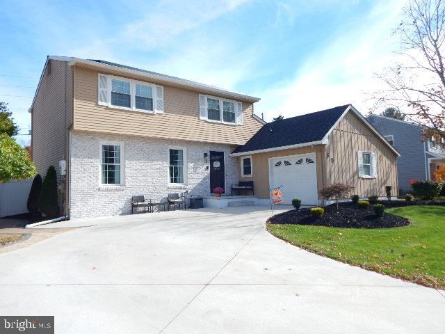 a front view of house with yard outdoor seating and barbeque oven