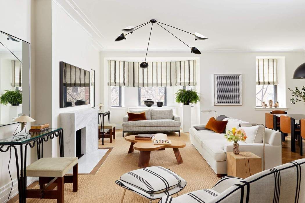 a living room with furniture fireplace and a window