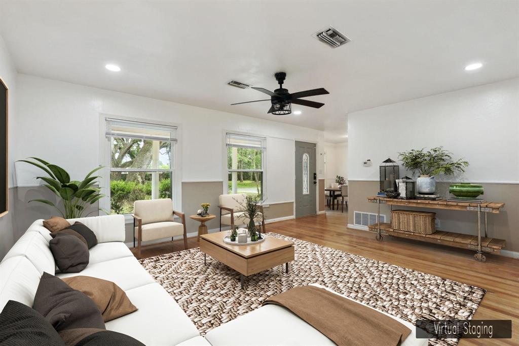 a living room with furniture a rug and a chandelier