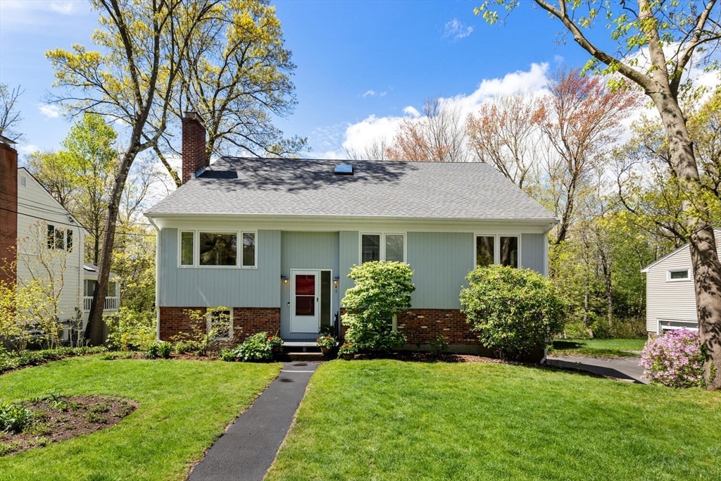 a front view of a house with a garden and plants