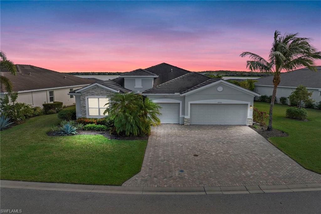 a front view of a house with a yard and garage