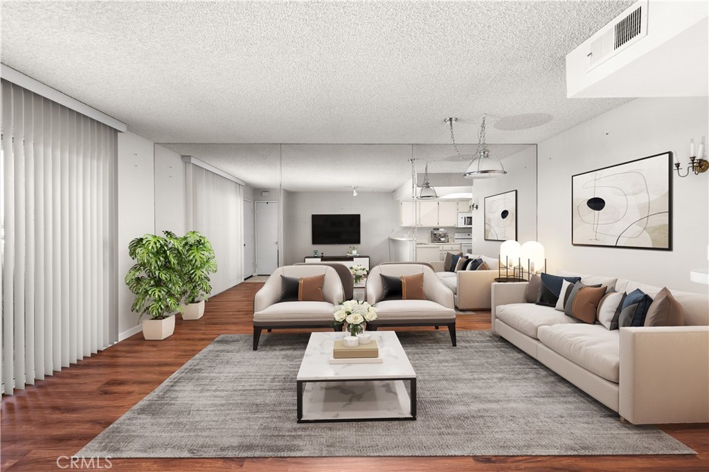 a living room with furniture and wooden floor