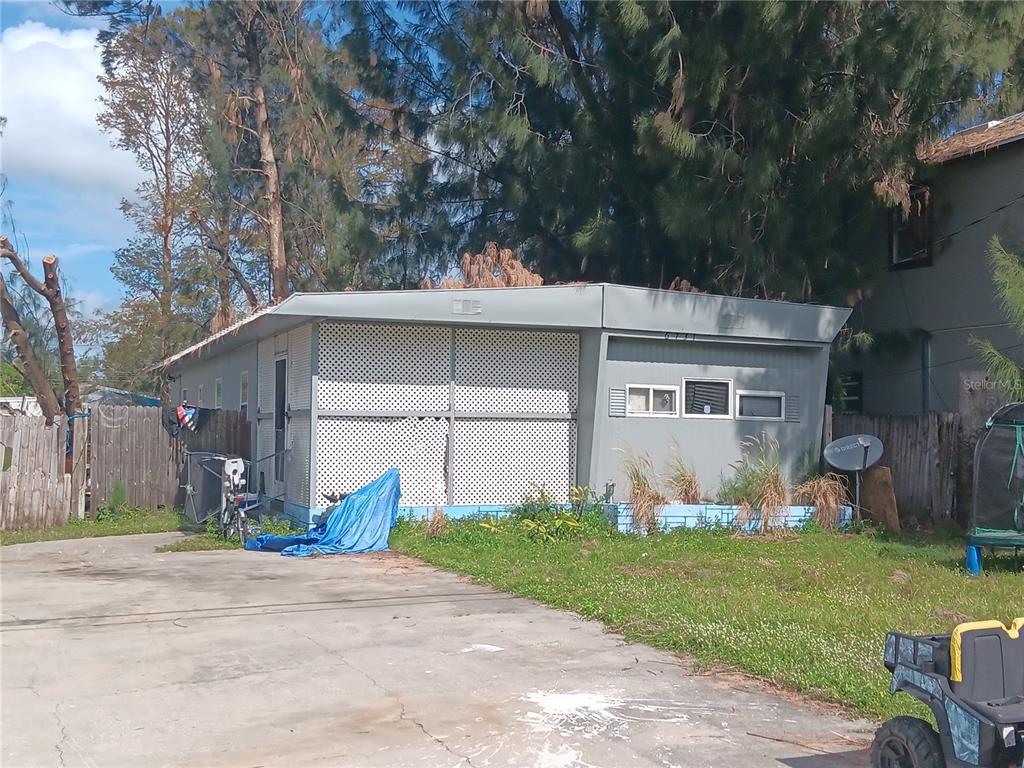 a front view of house with yard and trees in the background