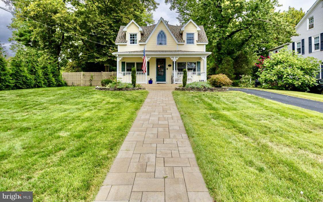 a front view of a house with a yard and potted plants