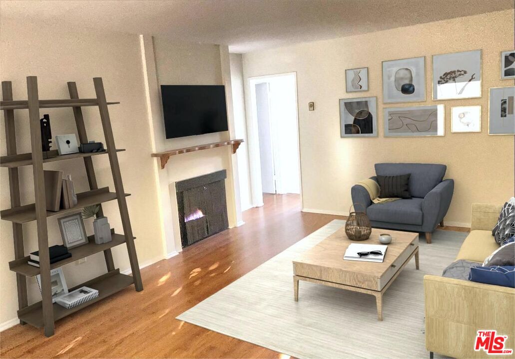 a living room with furniture a rug and a flat screen tv