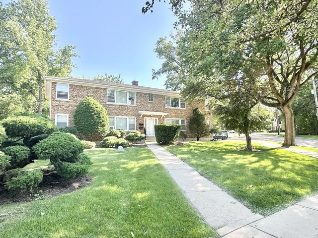 a house view with a sitting space and garden