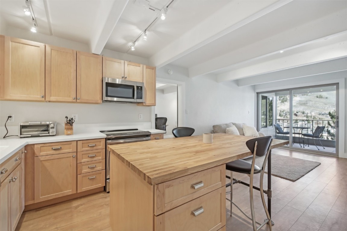 Remodeled kitchen with new appliances and finishes.